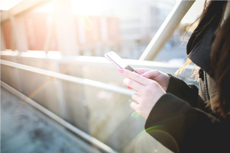 Girl with Smartphone in Sunlights